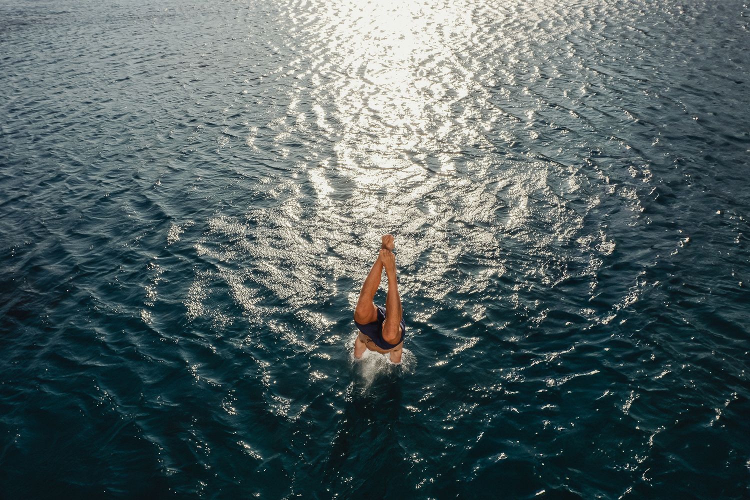 A series of swimming images shows a person moving through sparkling blue water with dynamic splashing effects.