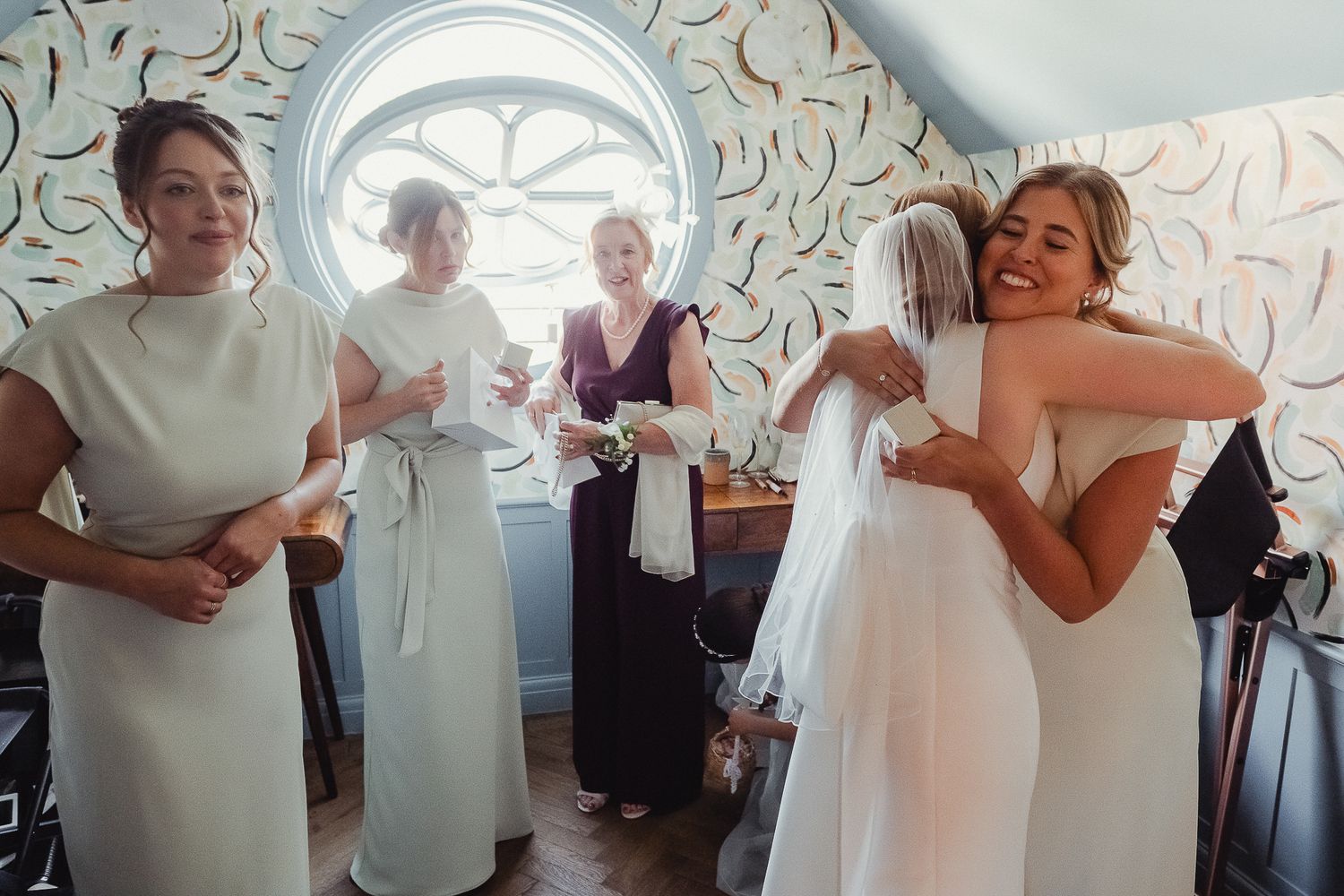 Bride and groom share their first dance surrounded by wedding guests at an intimate reception venue.