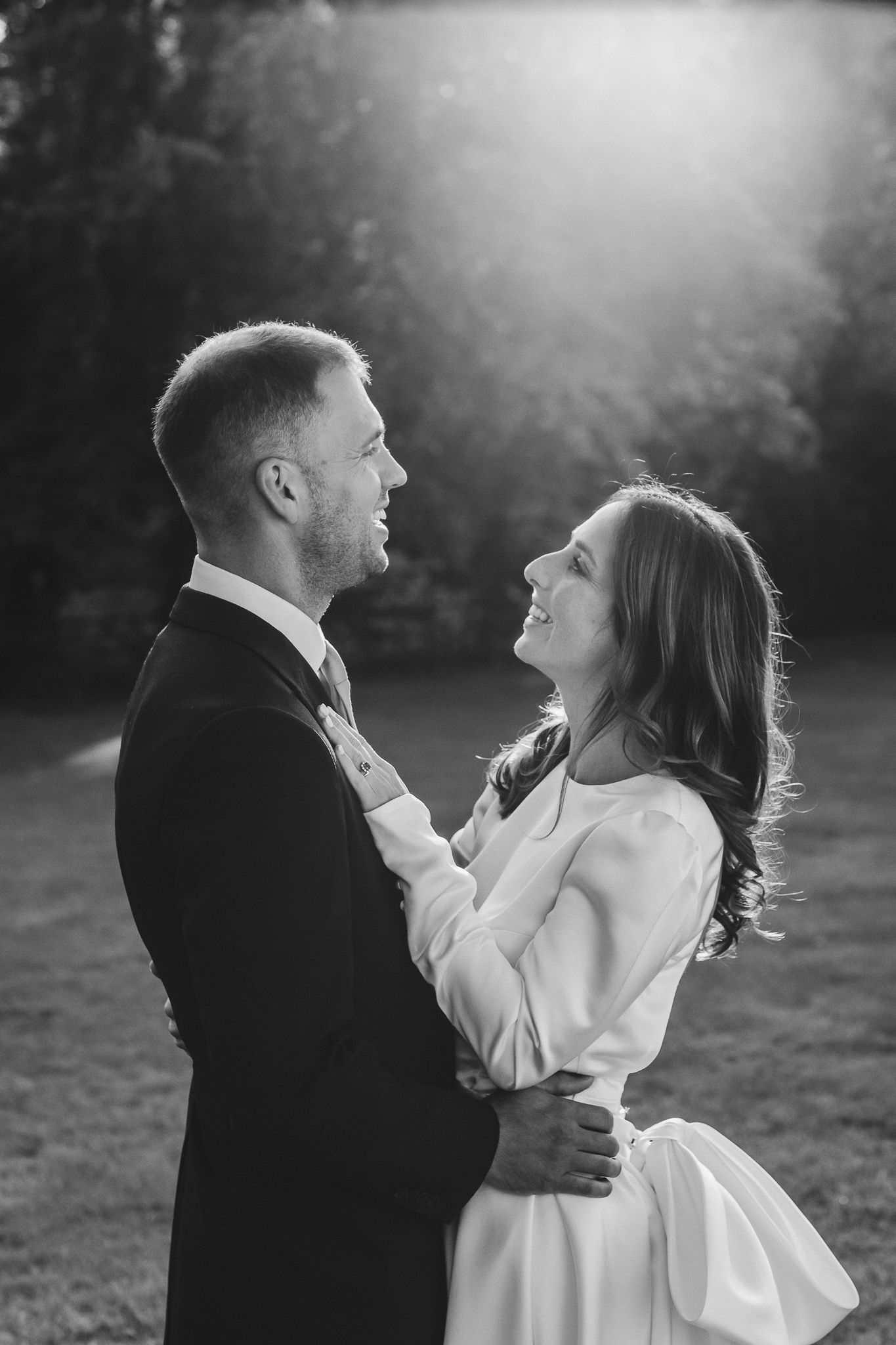A romantic black and white photo sequence shows a couple dancing and laughing together in an outdoor setting.
