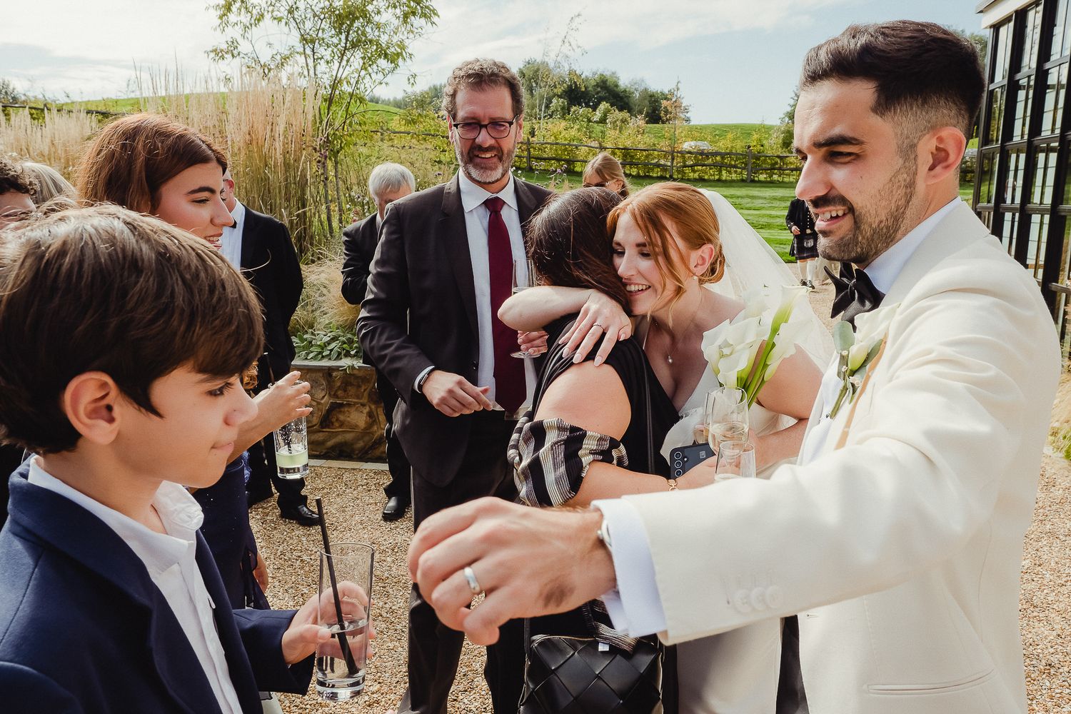 A magician performs an entertaining trick with bubbles during an outdoor wedding celebration.