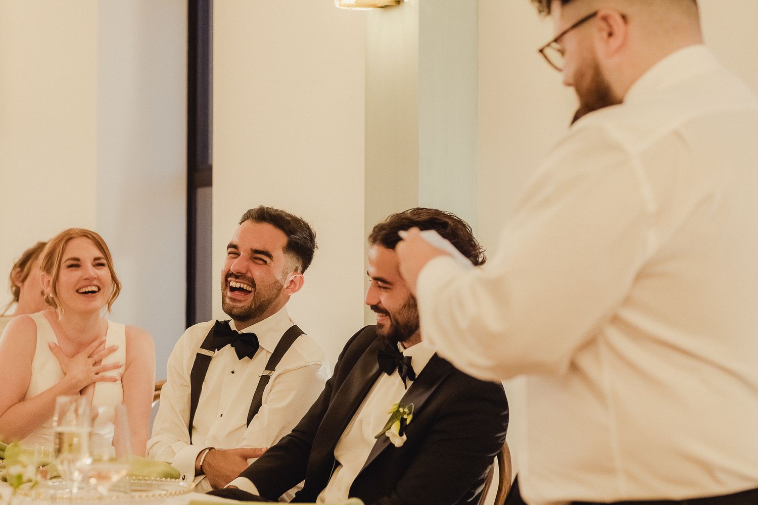 A collection of candid wedding reception photos showing joyful moments between guests and newlyweds.