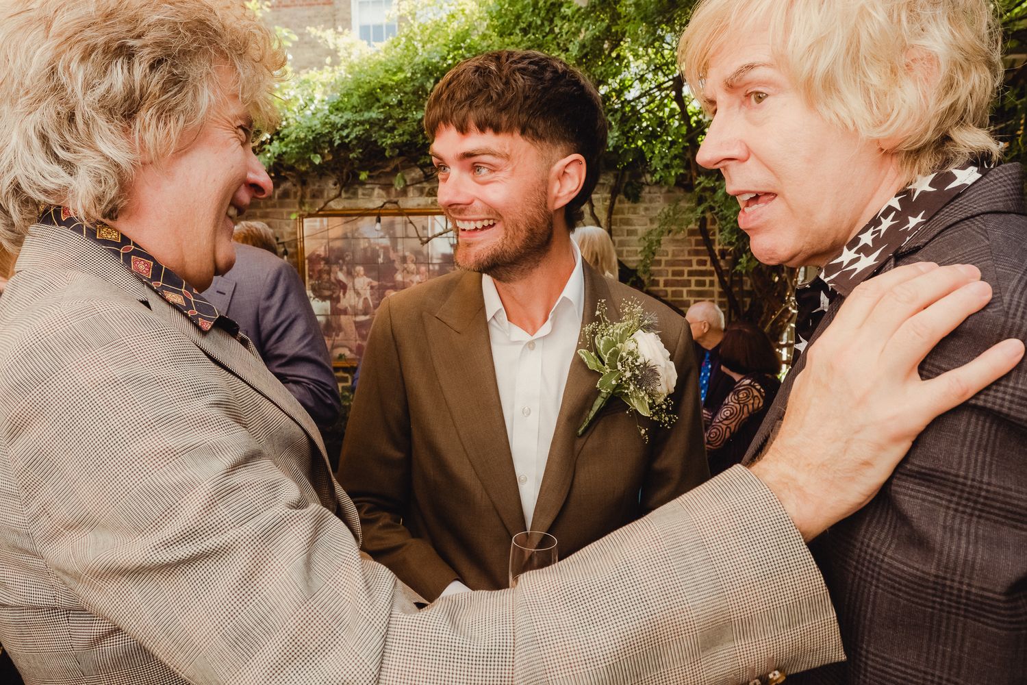 A series of candid photos showing joyful interactions and embraces between people at an outdoor gathering.