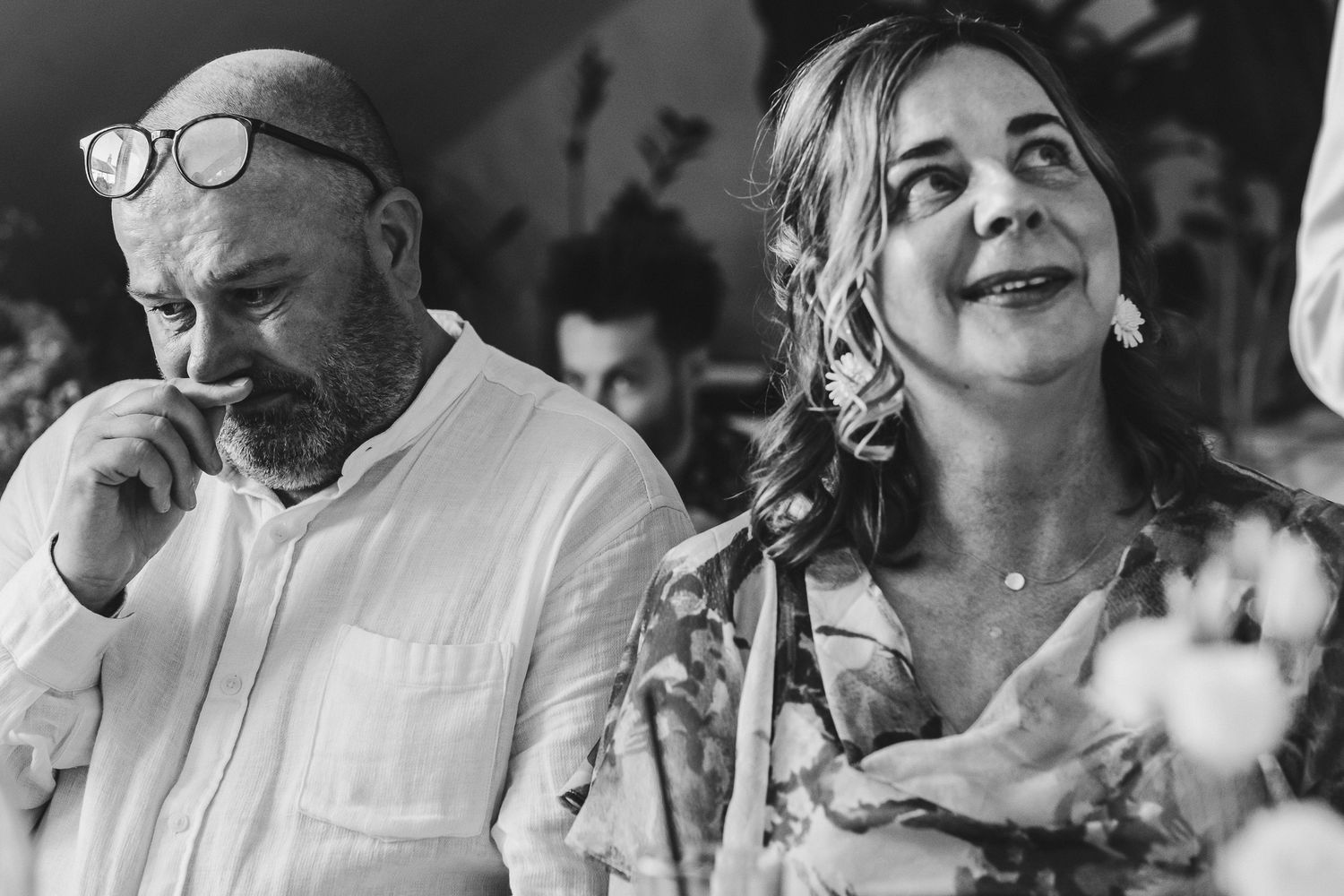 A black and white photo collage shows people laughing and expressing joy in candid moments.