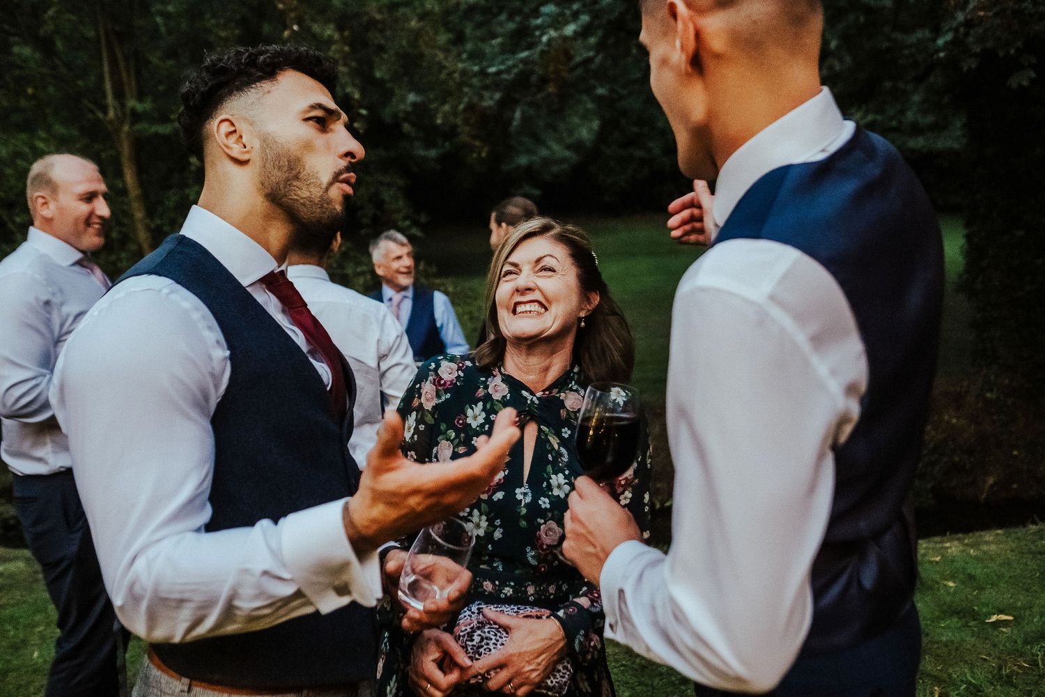 Joyful dance celebration at an outdoor evening wedding reception.