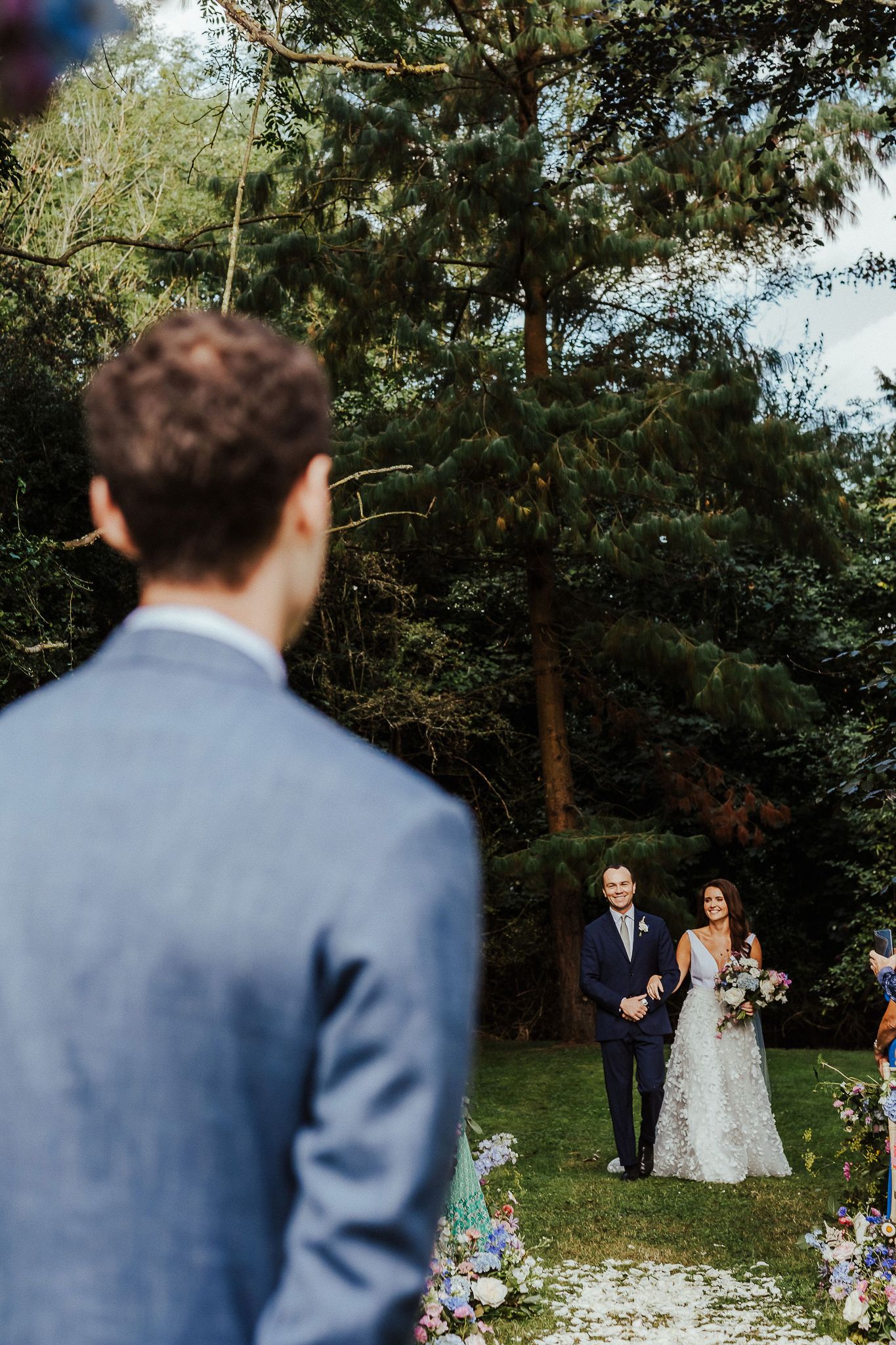 Wedding ceremony takes place in a serene garden setting with natural decor.