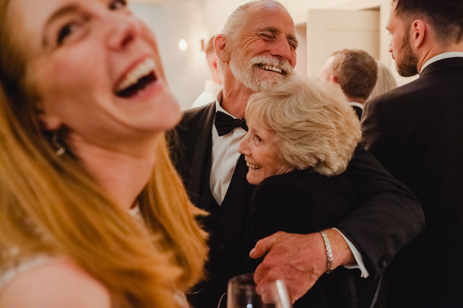 A series of candid moments showing people laughing and enjoying themselves at a social gathering.