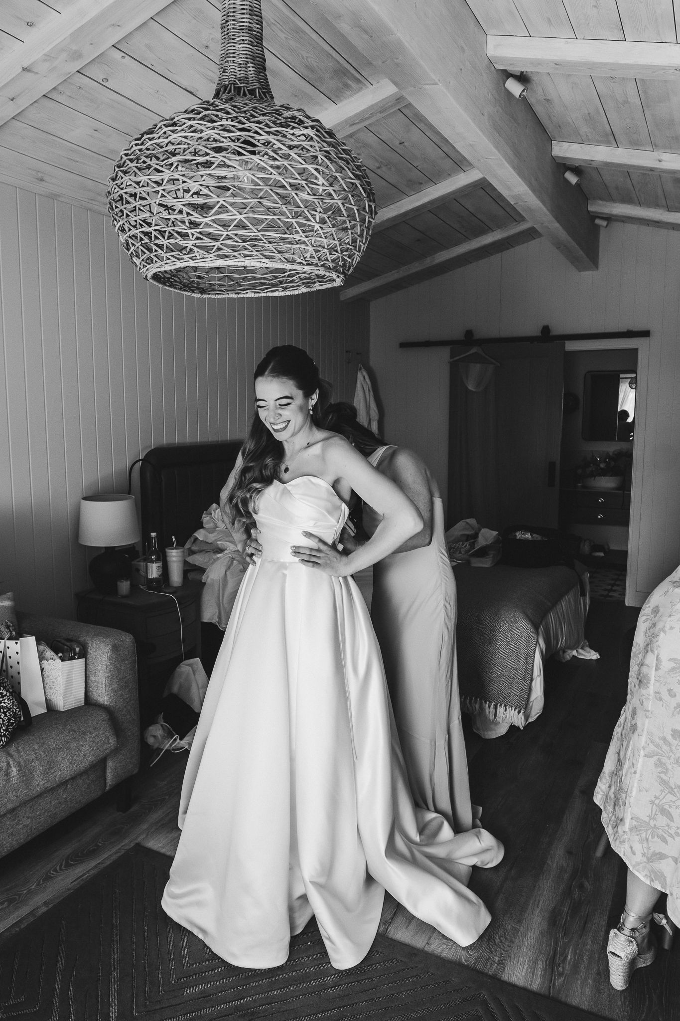 A sequence of black and white photographs showing people getting ready in a rustic room with white wooden walls and ceiling.