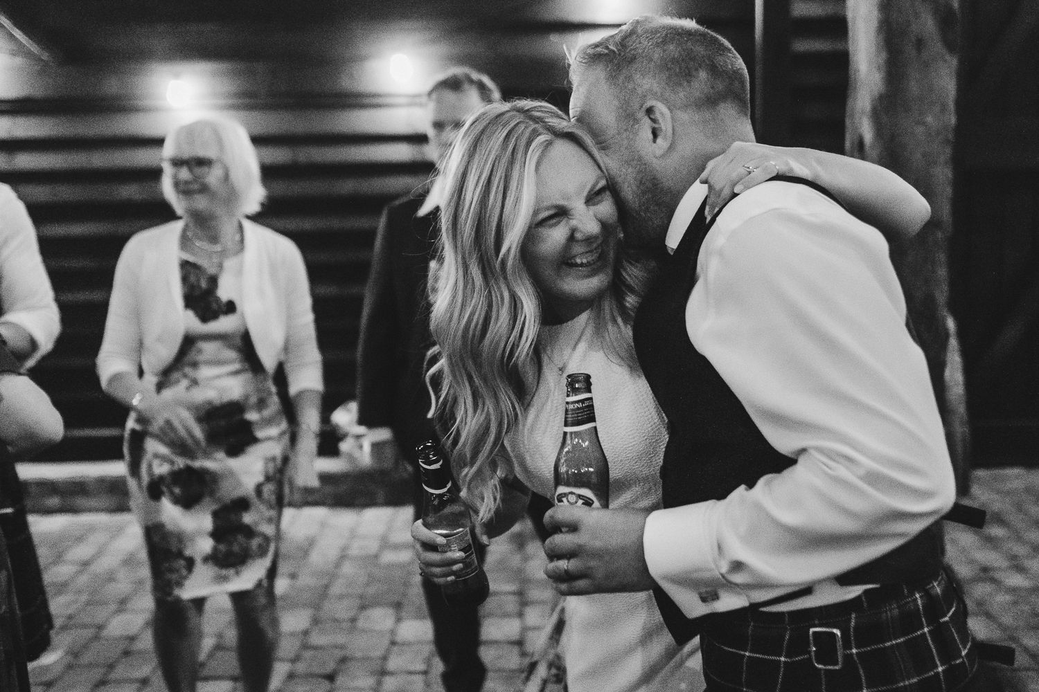 Black and white photo sequence showing joyful dancing and celebration at a wedding reception.