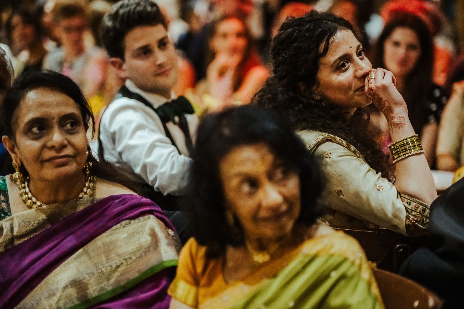 Guests in traditional attire enjoy themselves during a festive celebration.