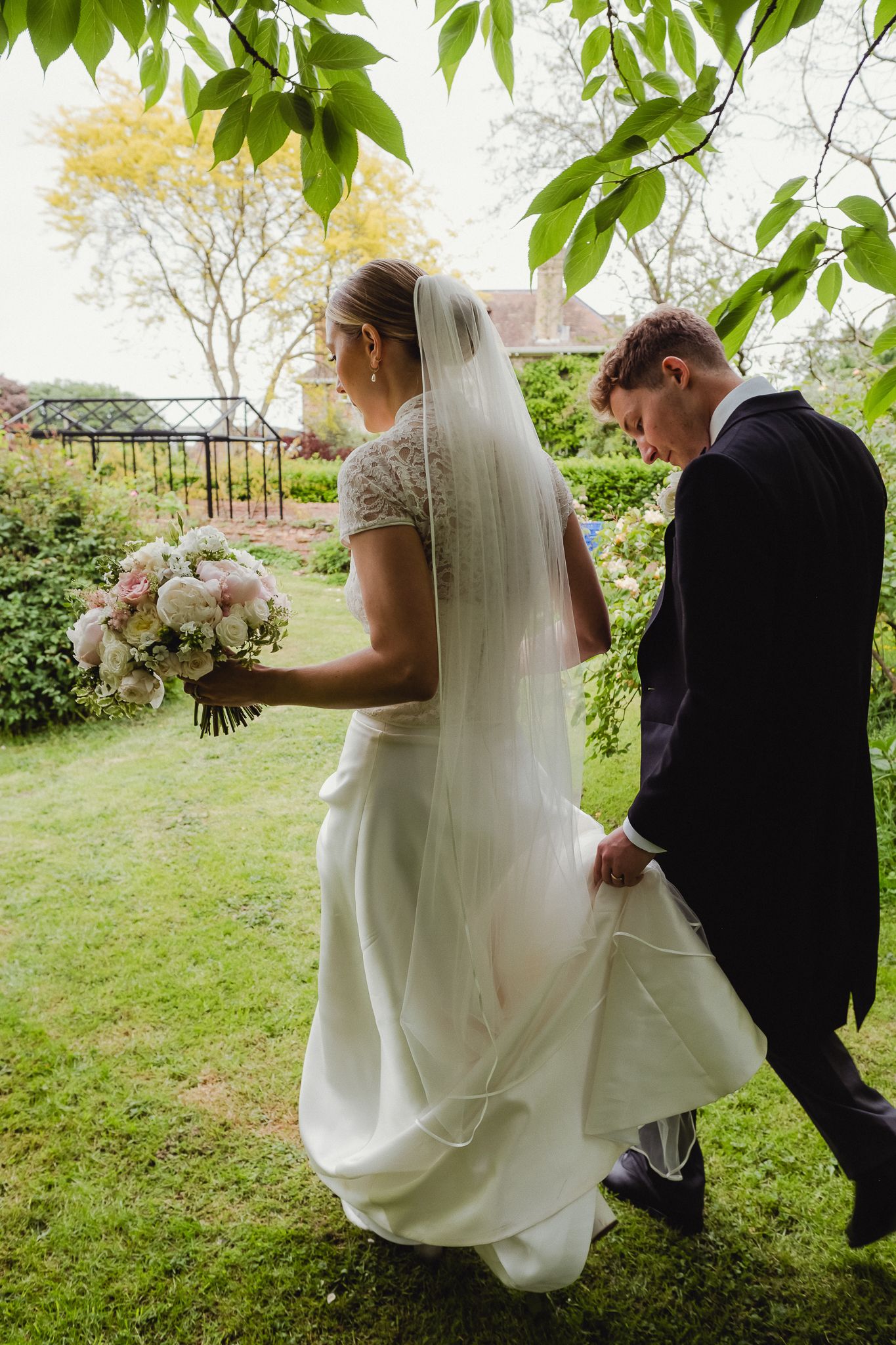Sequence of wedding photos showing couple walking together on grassy lawn with bride's white dress flowing in the breeze.