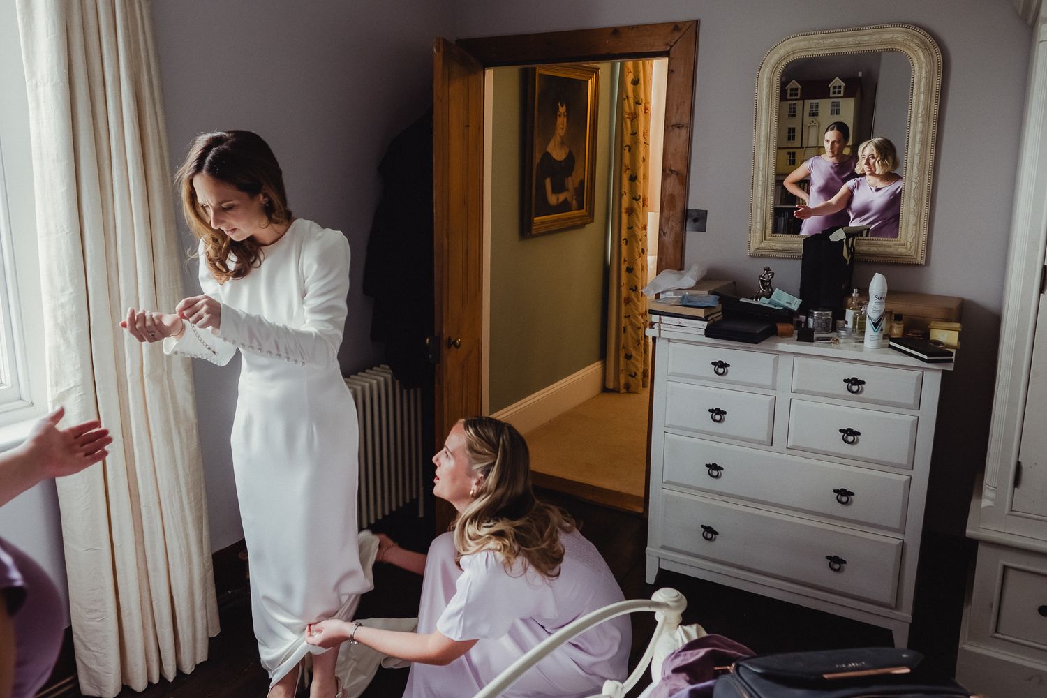 A series of images showing a bride getting ready for her wedding day in a sunlit dressing room.