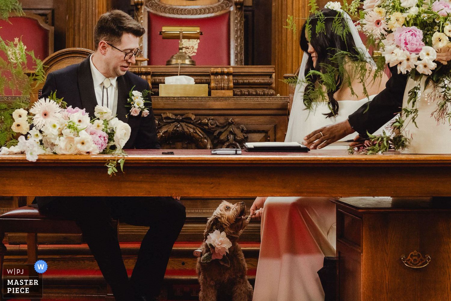 A rustic wedding ceremony venue decorated with white floral arrangements and wooden benches in a traditional church setting.