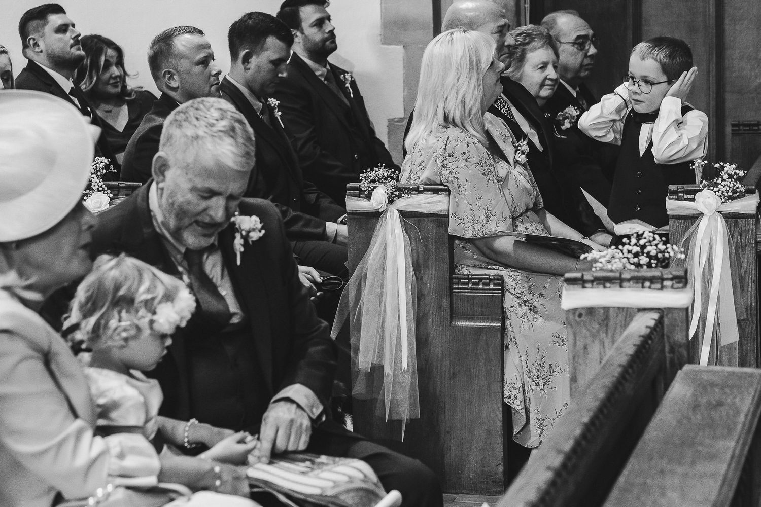 A black and white collage of candid moments at a wedding reception showing dancing, dining and celebration.