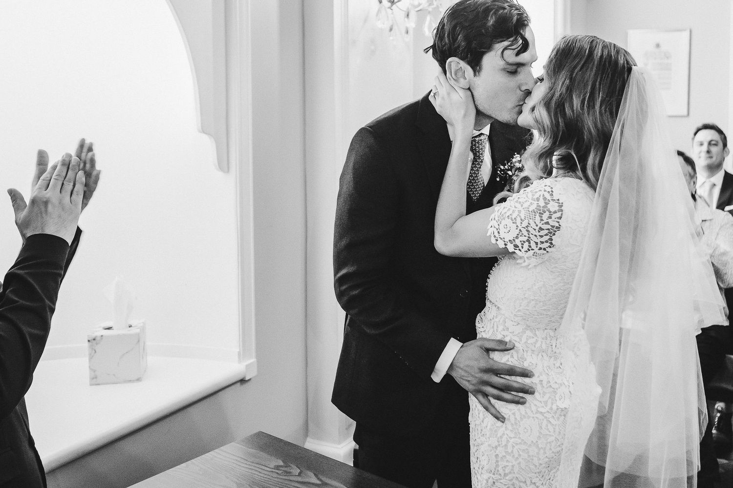 A black and white wedding photo collage showing intimate moments between newlyweds during their special day.