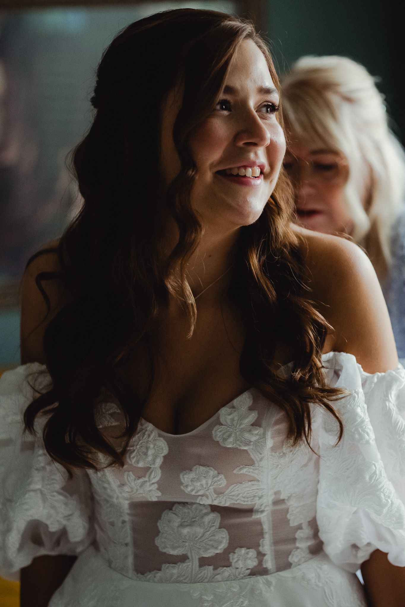 Two people in wedding attire share an intimate moment while laughing and embracing in a series of candid photos.