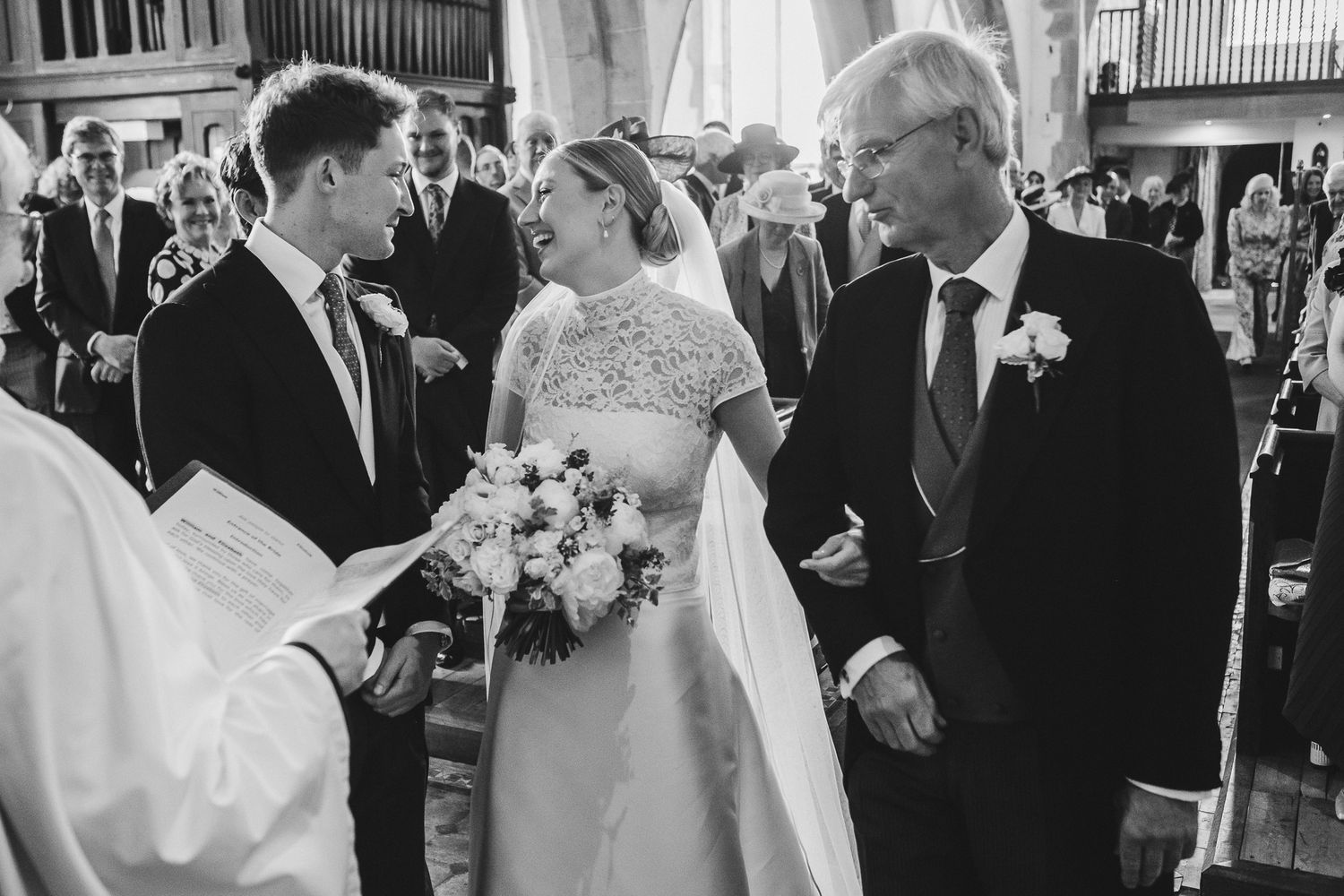 A wedding celebration with guests dancing and celebrating in a beautifully decorated indoor venue.