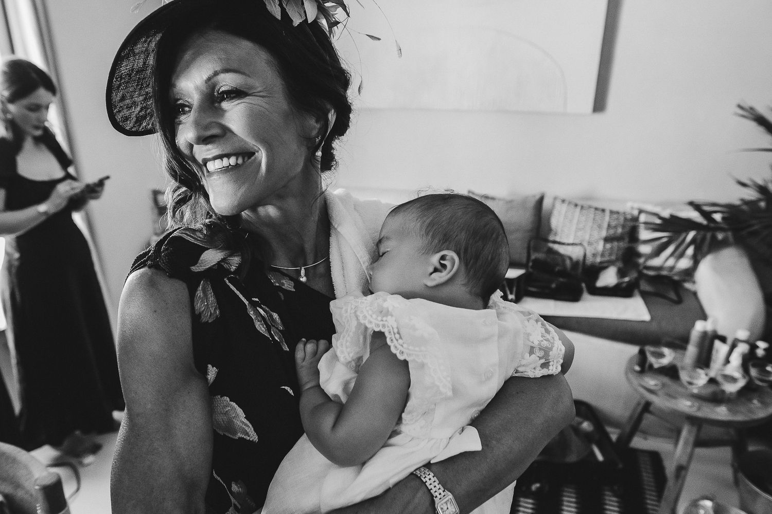 Black and white photo collage showing three candid moments of people laughing and embracing at social gatherings.