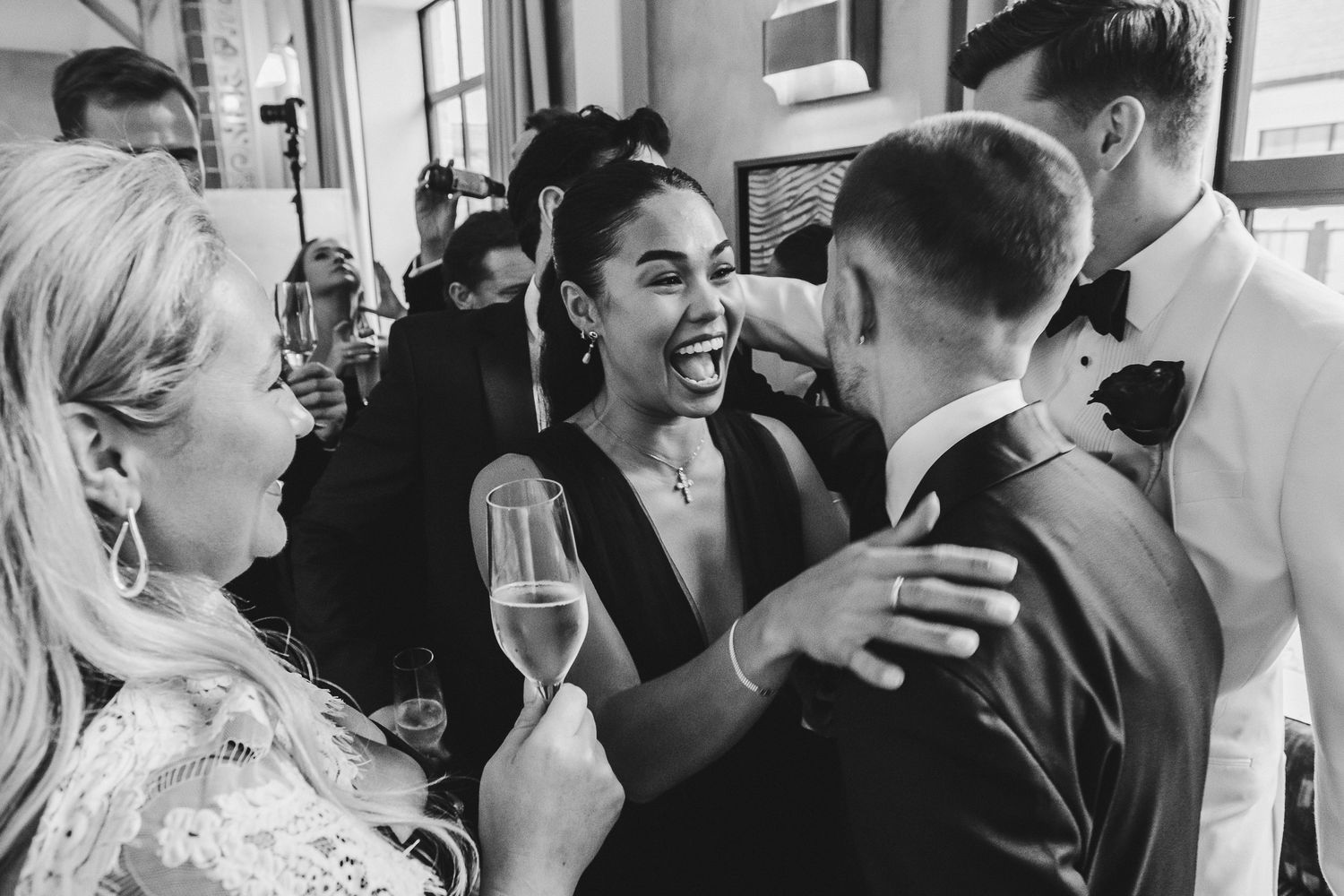 Guests mingle and socialize at an elegant indoor wedding reception.