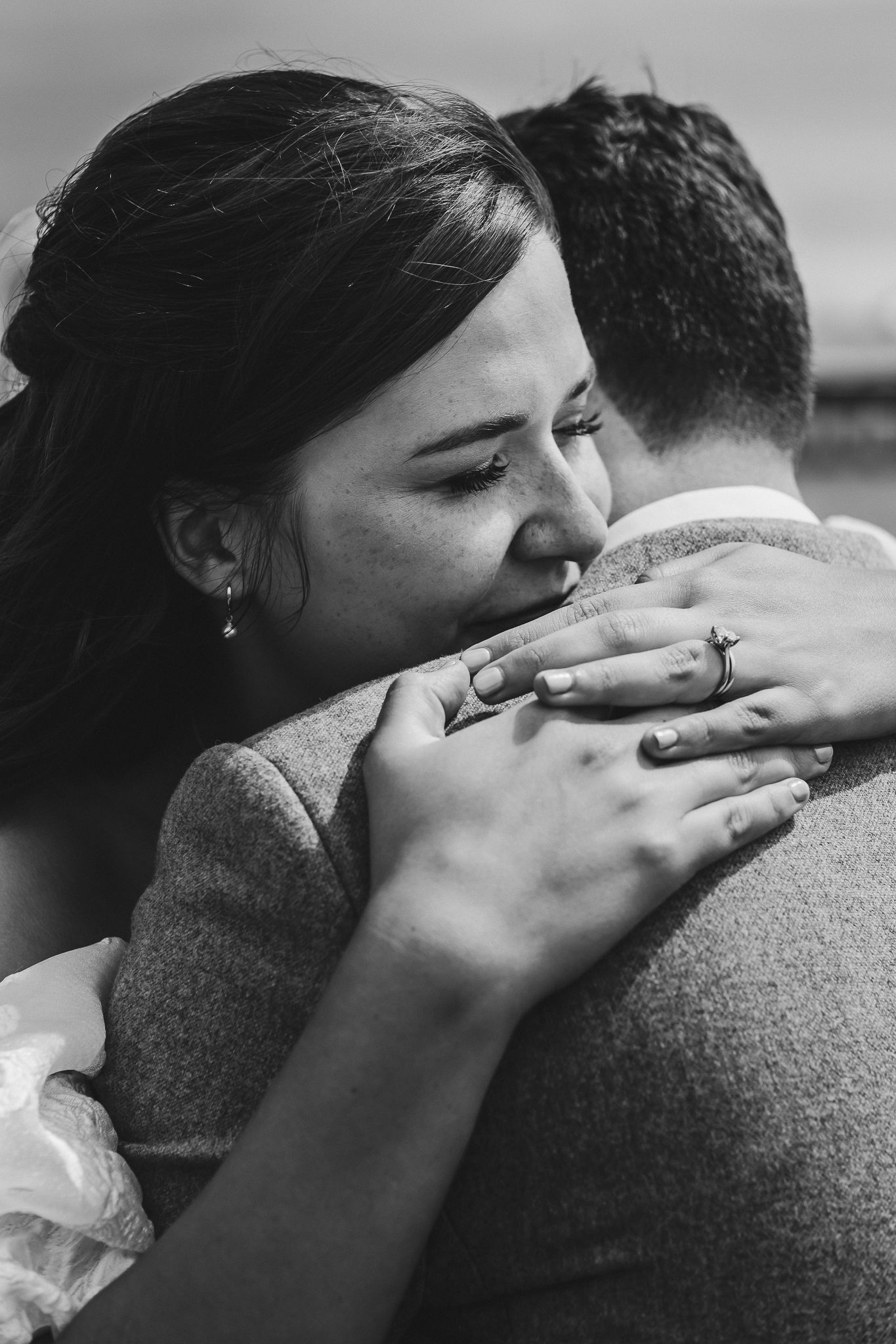 A series of black and white photographs showing an intimate embrace between two people in similar poses.