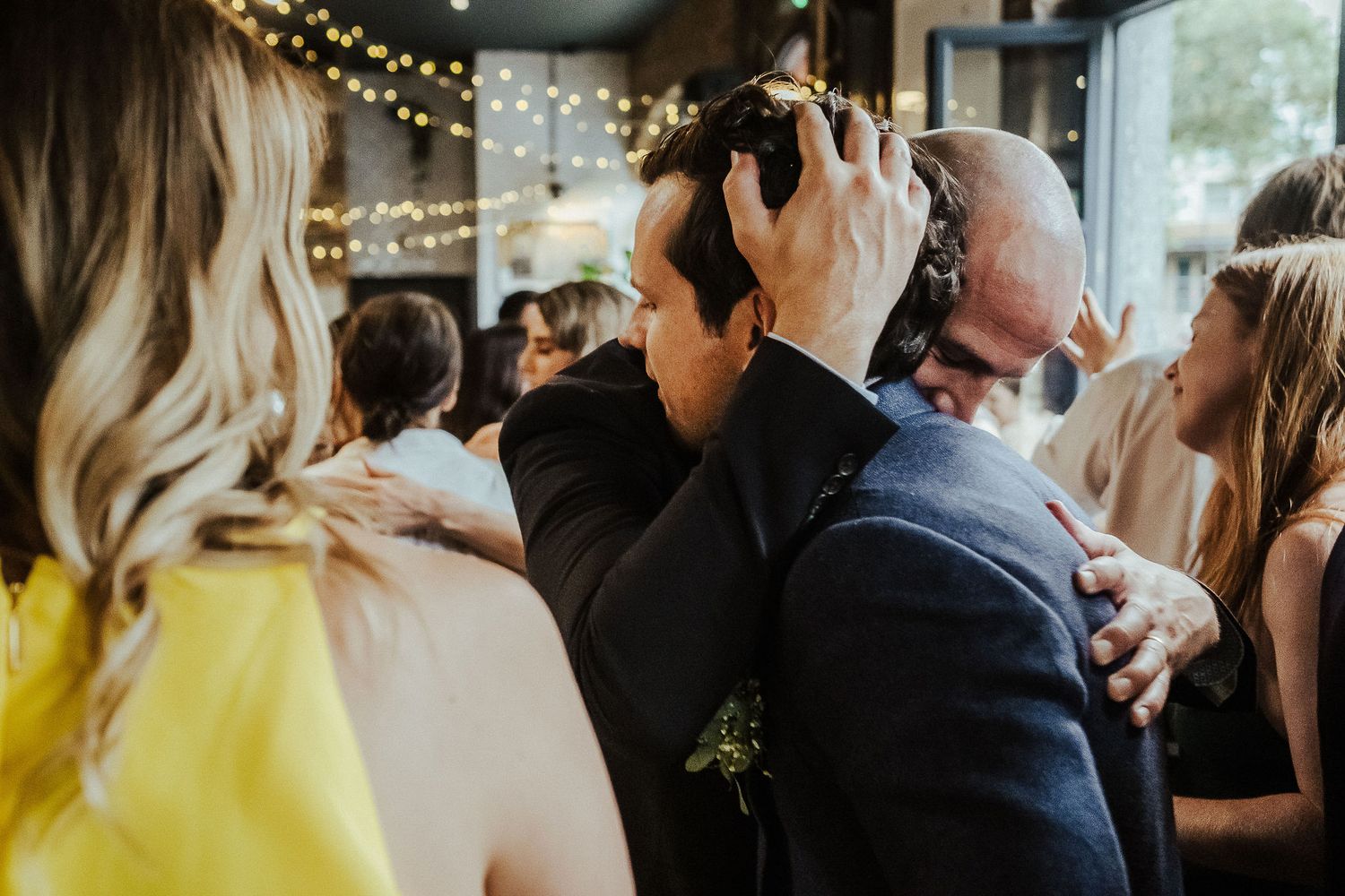 Wedding reception venue decorated with warm string lights creating an intimate atmosphere.