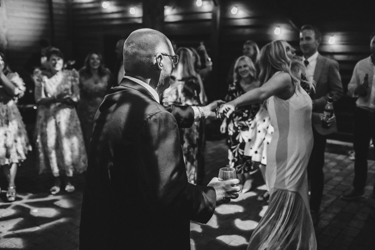 Black and white photo montage of people dancing and celebrating at a lively wedding reception party.