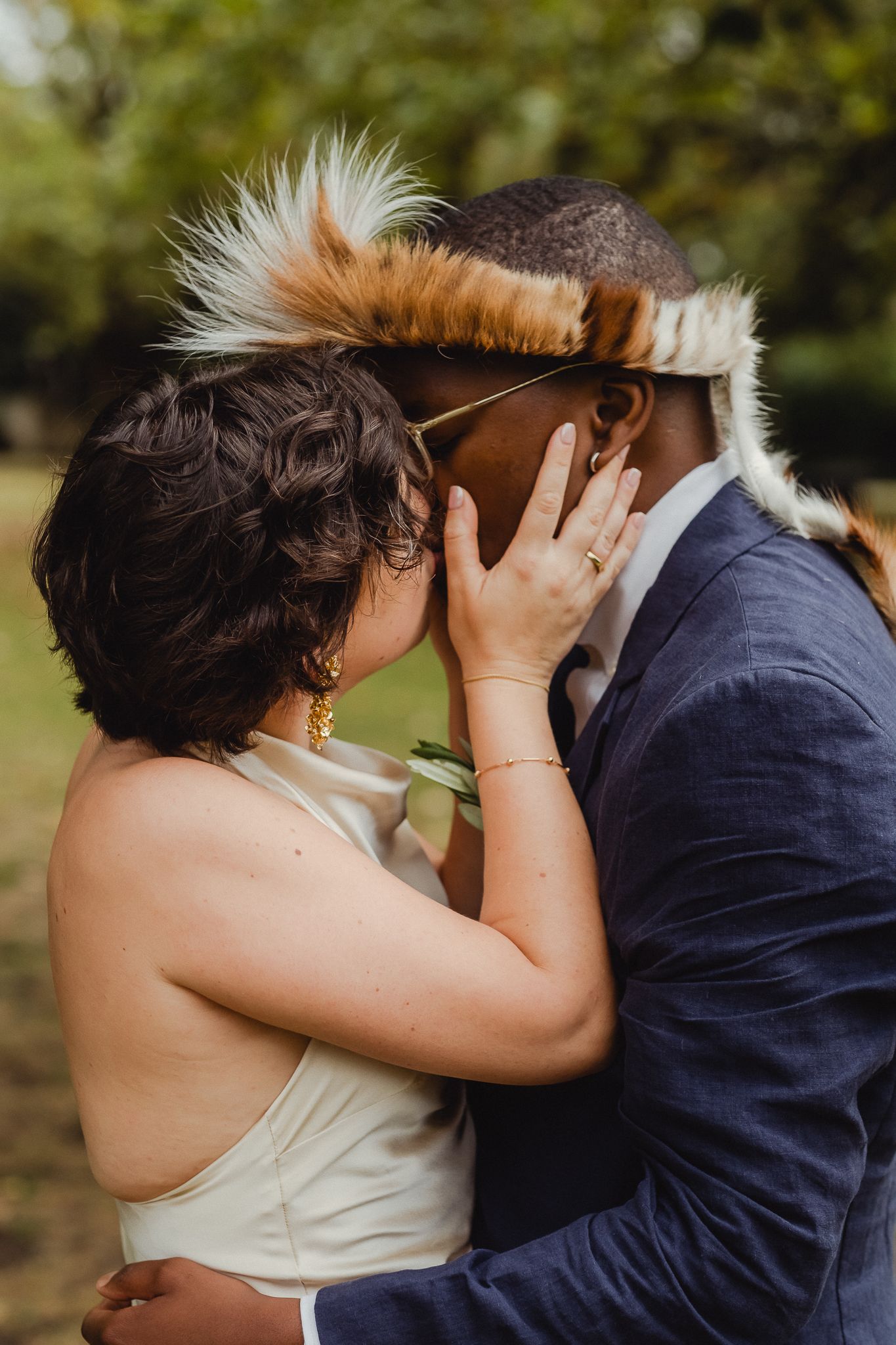 A romantic wedding couple shares intimate kisses in a series of candid outdoor portrait photographs.