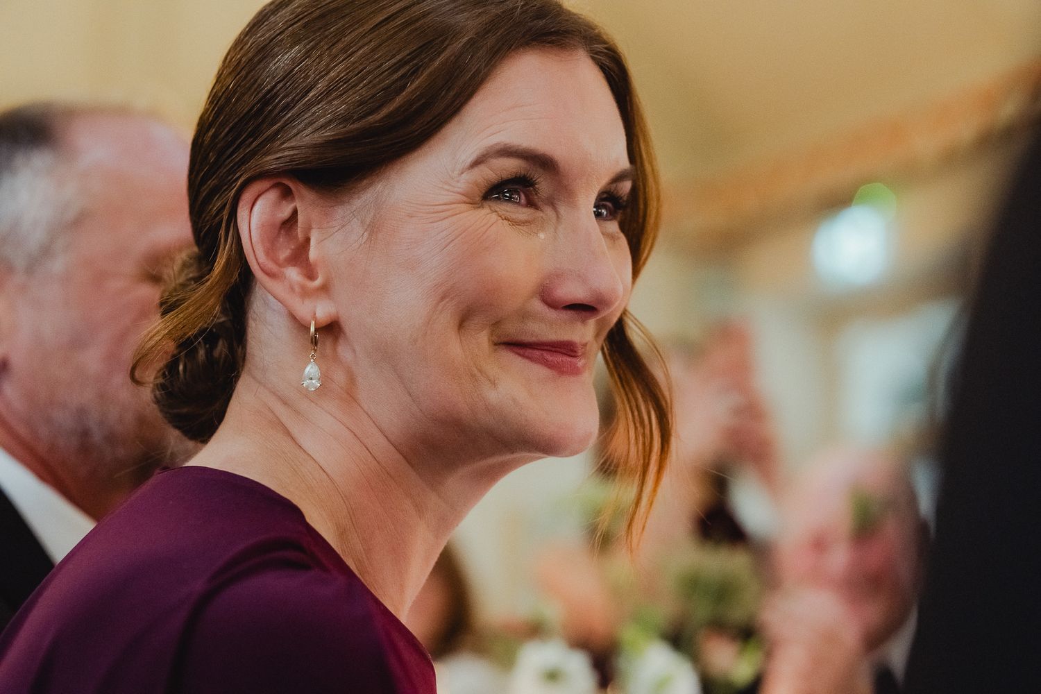 A close-up candid photo showing genuine laughter and joyful expressions during a celebration.