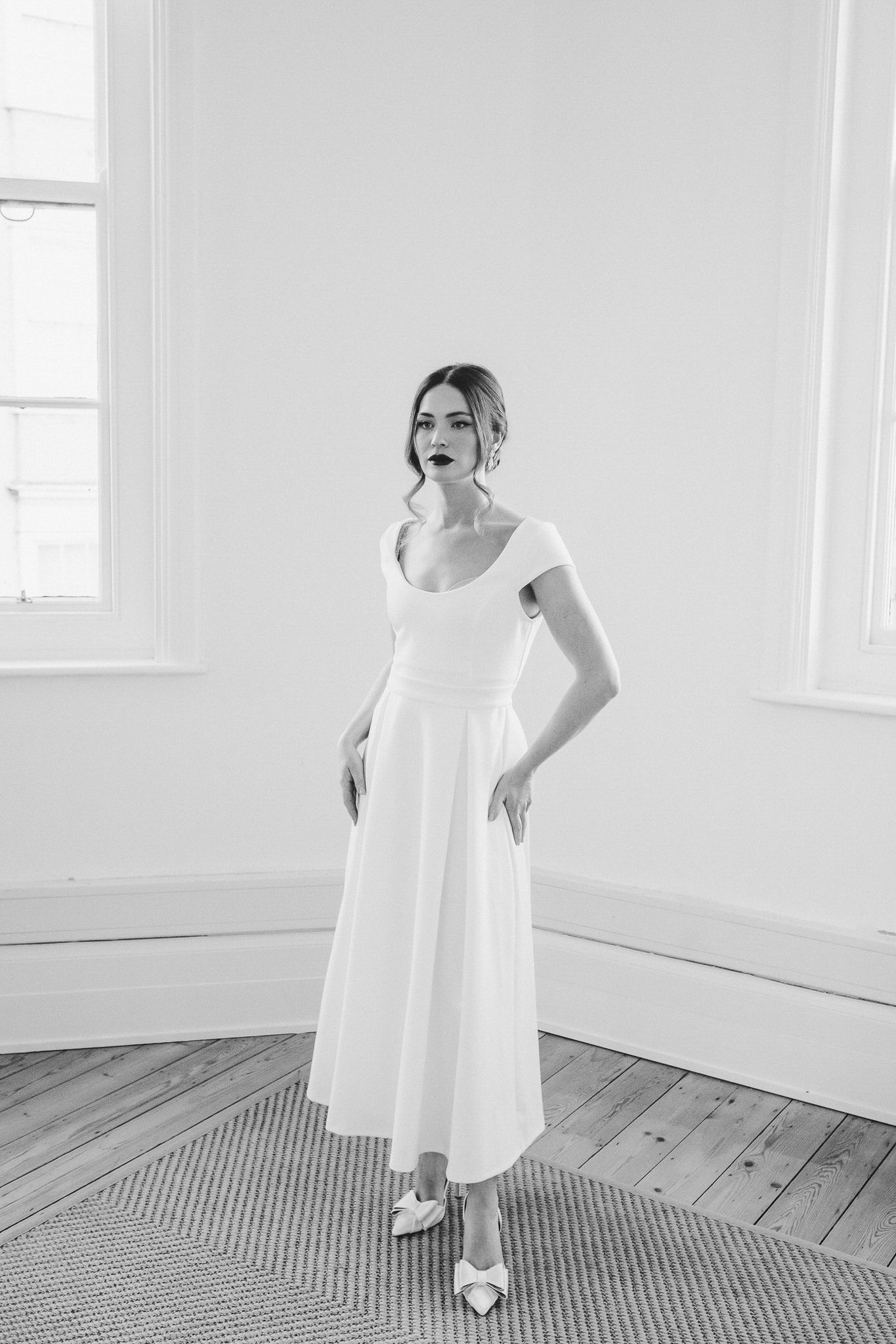 A series of minimalist black and white photos showing a figure in a flowing white dress against a light interior space.