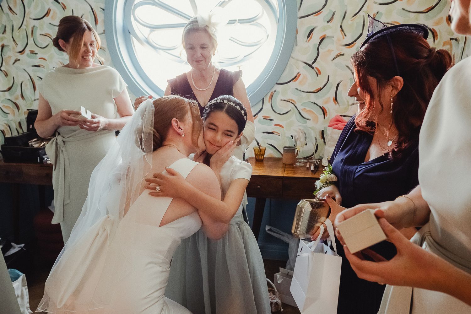 Wedding guests dance together in formal attire during a reception celebration.