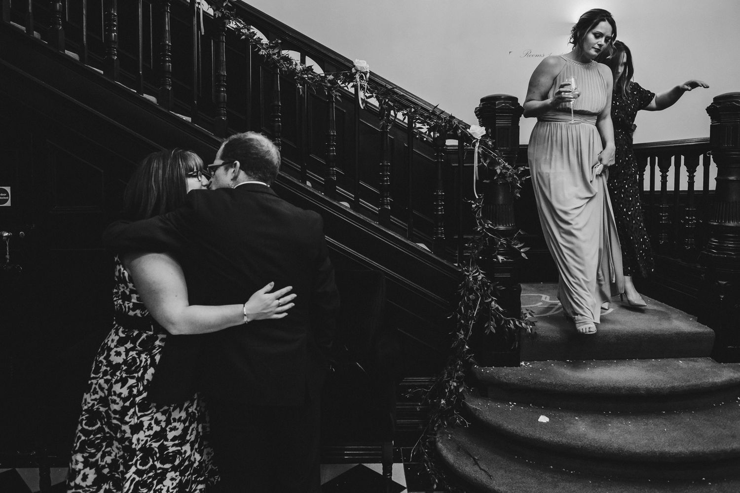 Artistic black and white photo of interior wedding venue with dramatic lighting.
