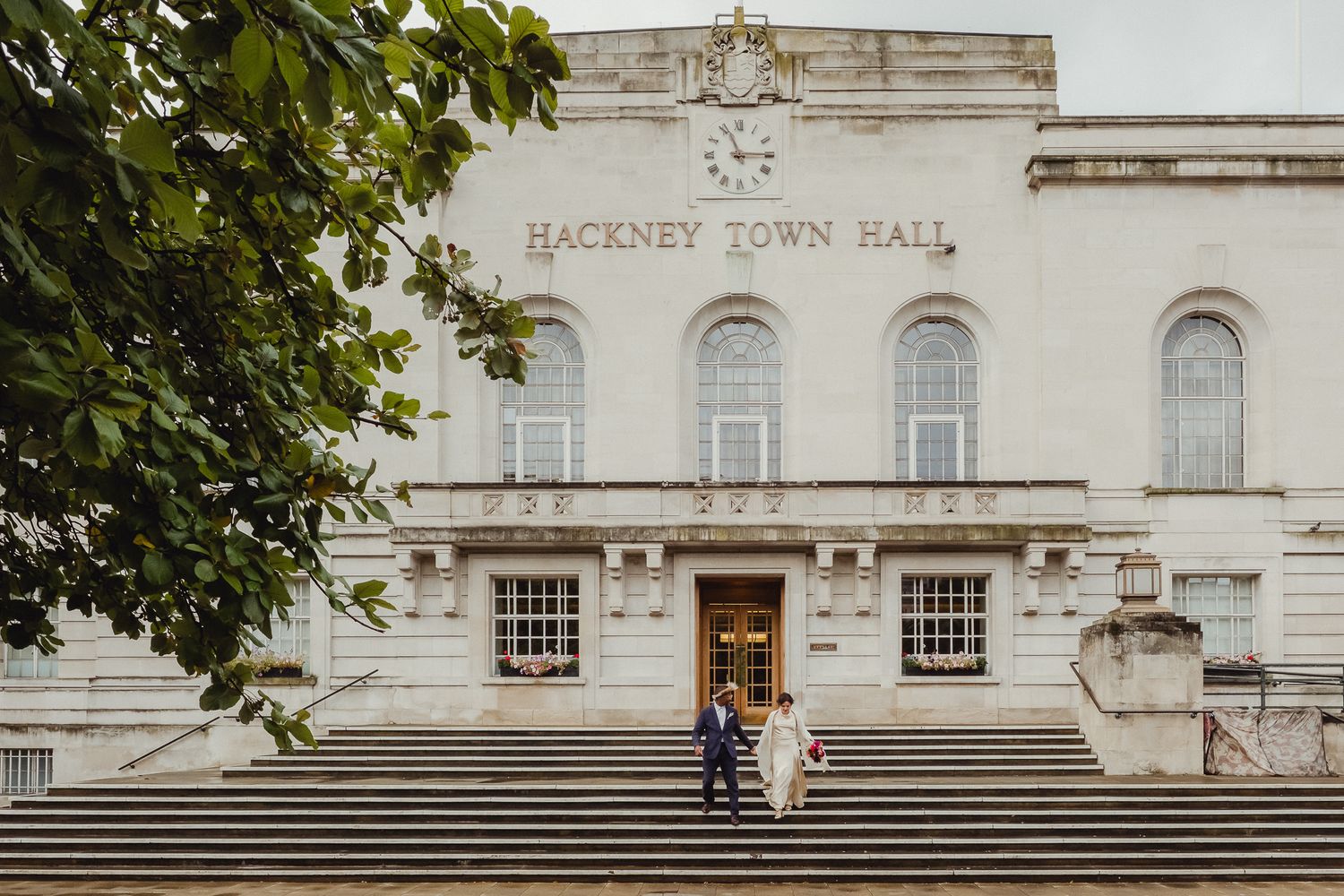 Historic white Hackney Town Hall building with grand steps and classical architectural features in London.