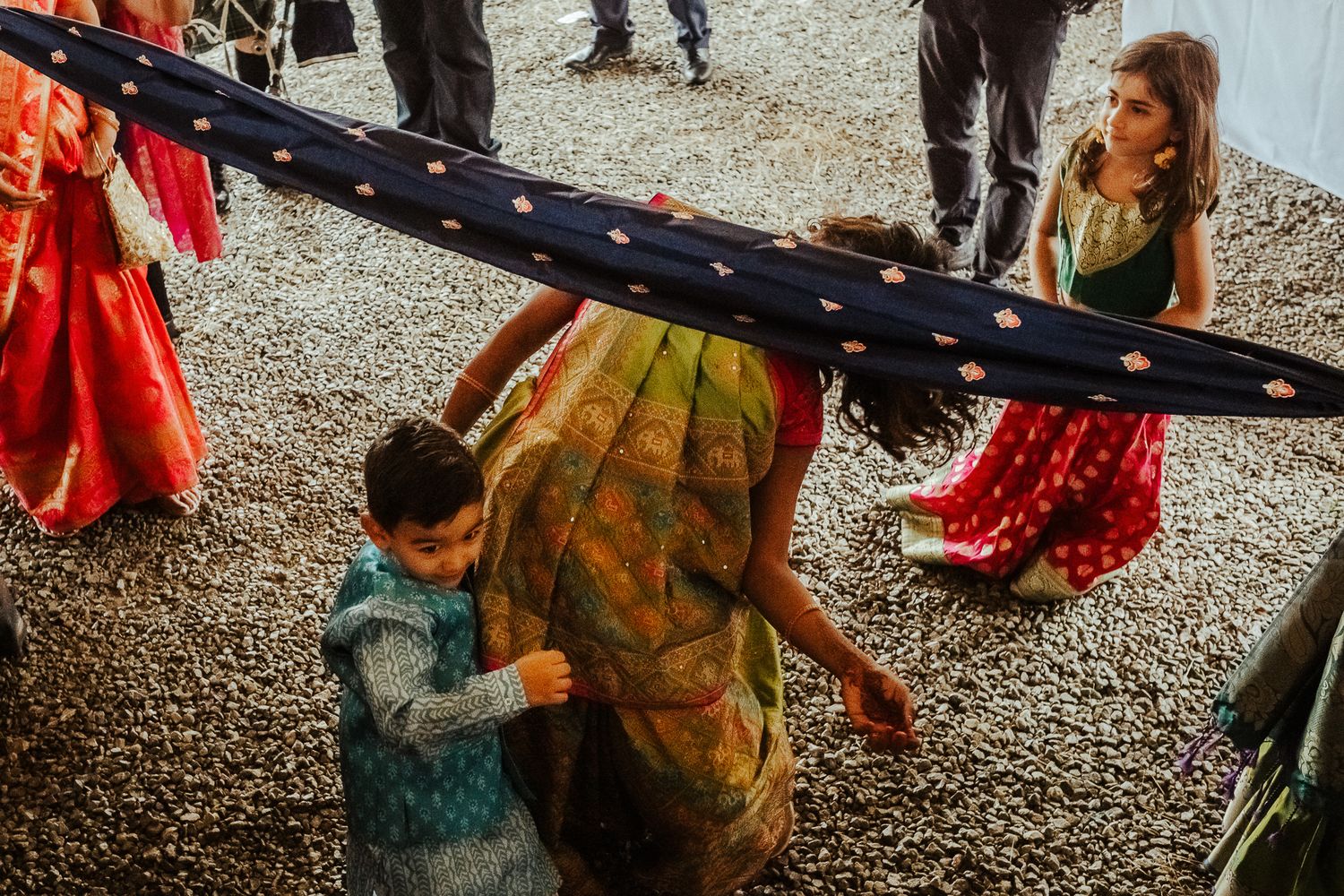 Two people interacting under a decorative canopy at a traditional cultural ceremony.