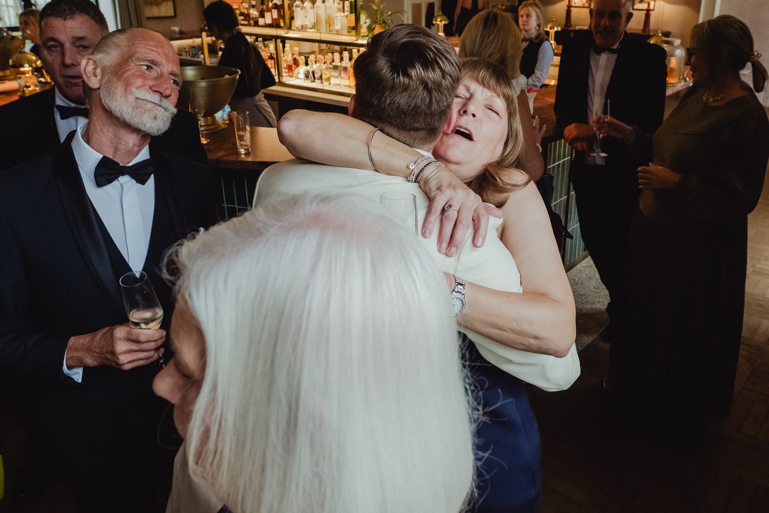 A couple shares a romantic dance together at an elegant wedding reception in a beautifully decorated ballroom.