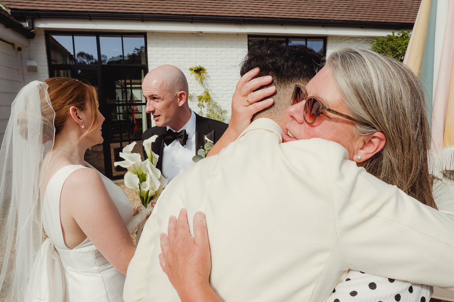 A collage of wedding celebration moments showing couples embracing and dancing at an outdoor reception venue.