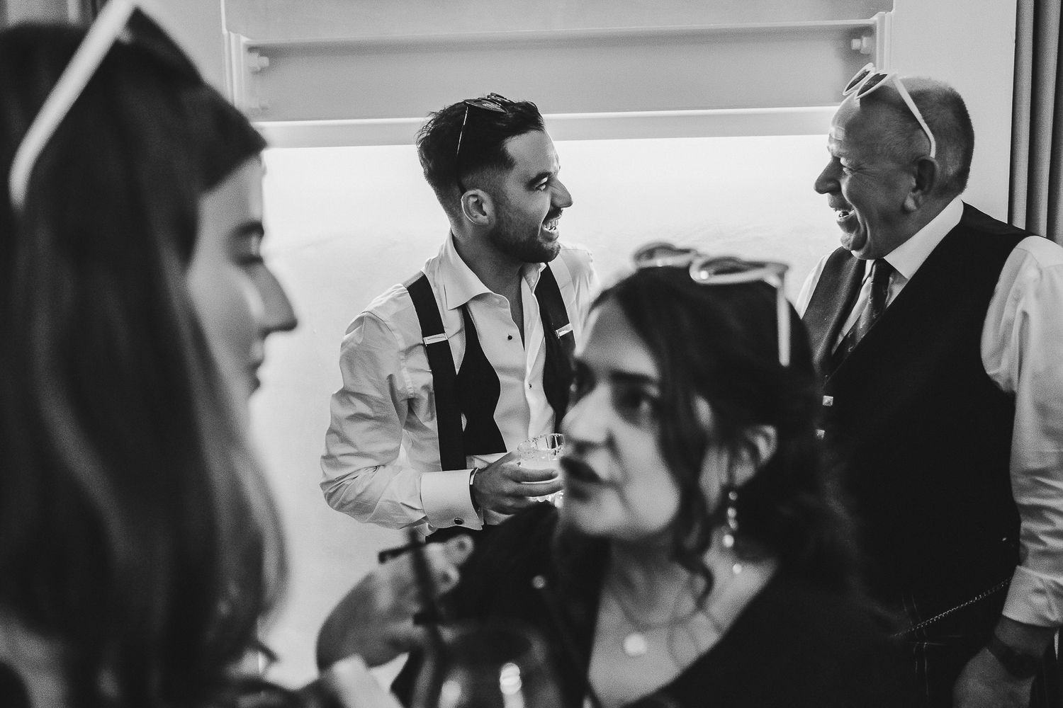 Black and white photo series showing candid wedding reception moments with dancing and celebration.