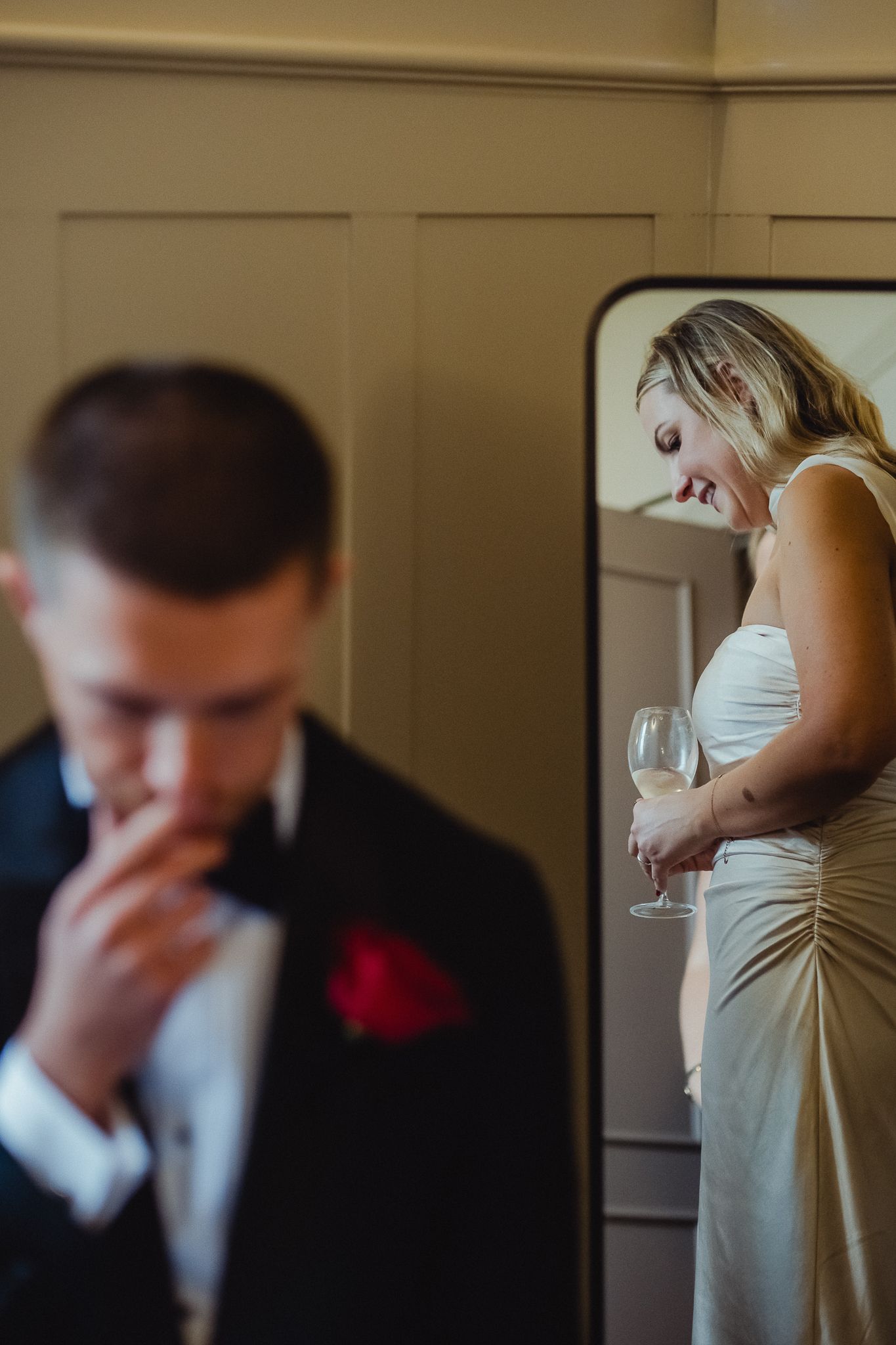 A series of five connected photos showing a couple's emotional first look moment at their wedding.