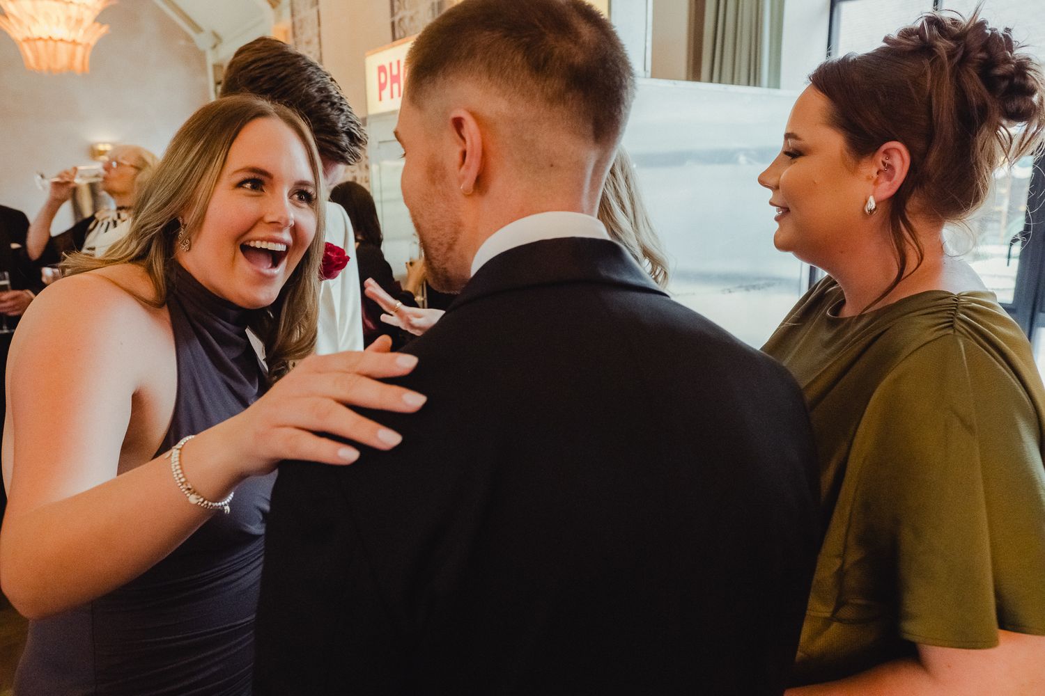 Candid moments of joyful dancing and embraces at a wedding reception celebration.