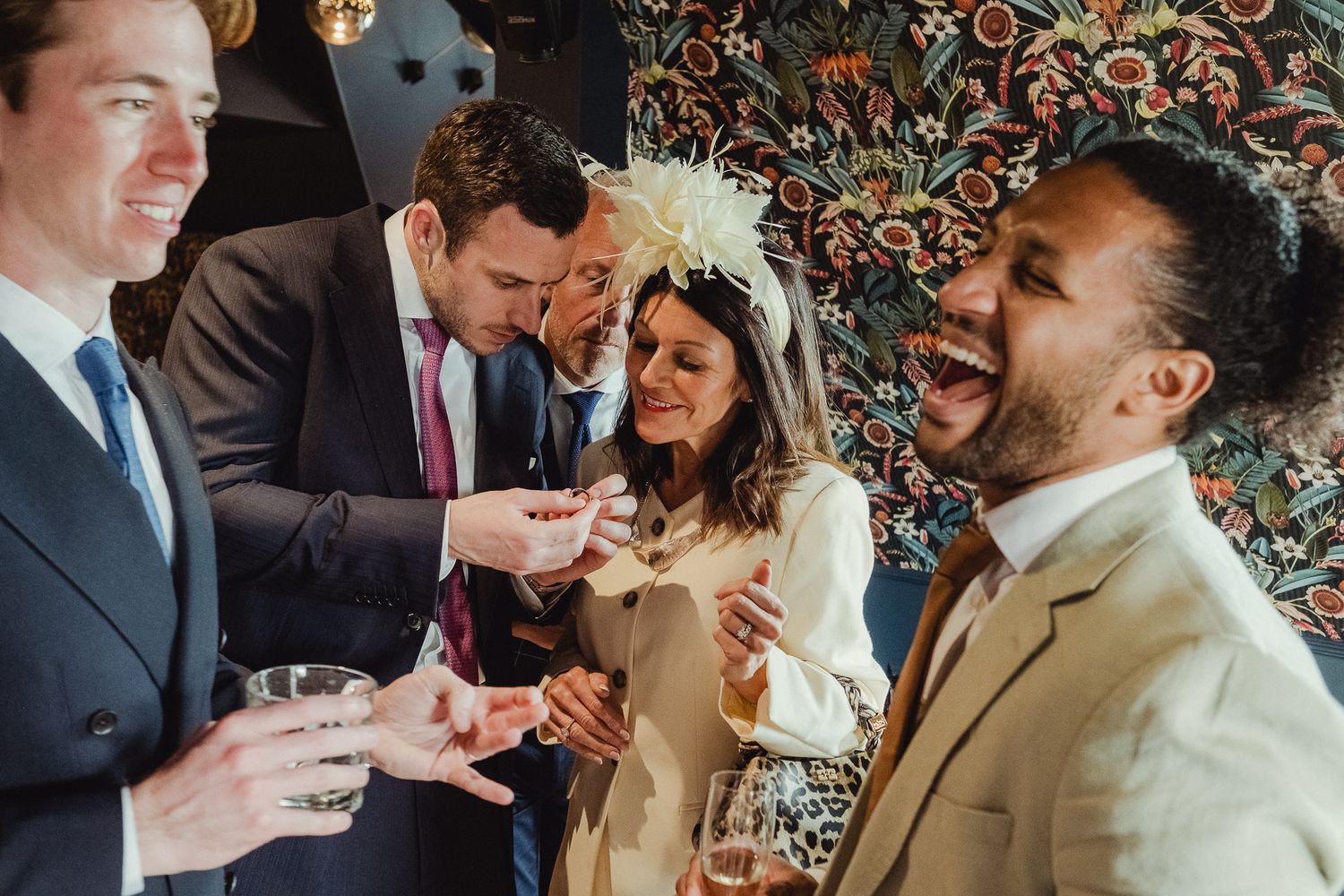 A series of candid wedding moments showing couples sharing joyful laughter and intimate interactions at a celebration.