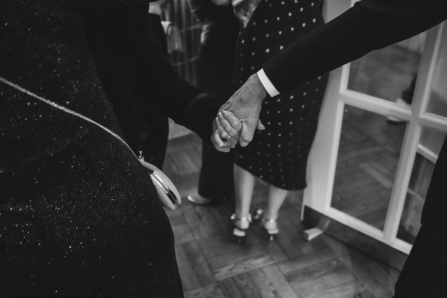 A black and white photo shows a person dancing in a polka dot dress at what appears to be a dance party or event.