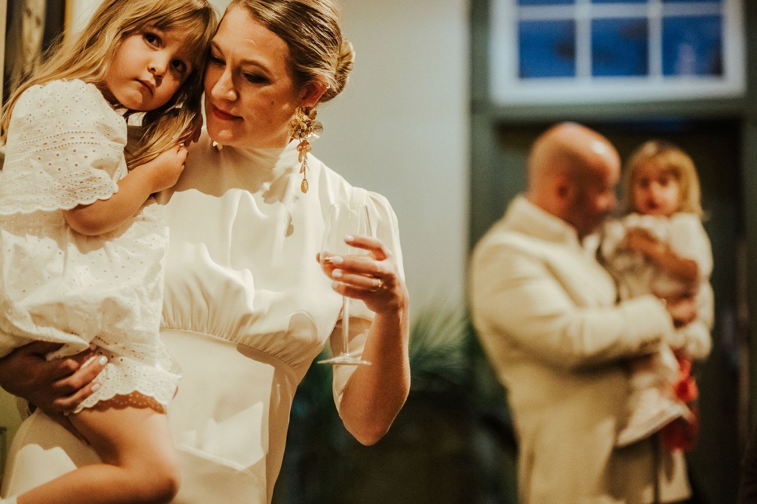 Intimate moment between couple in white outfits during photoshoot.