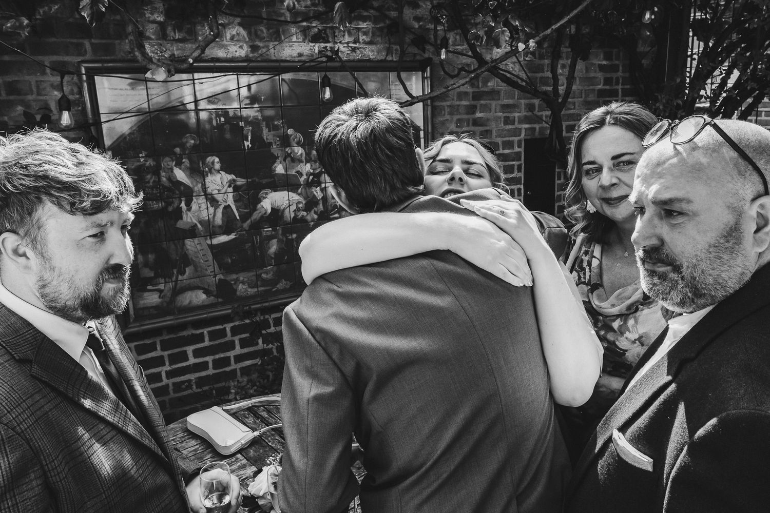 A series of black and white photographs showing people in various candid moments and interactions.