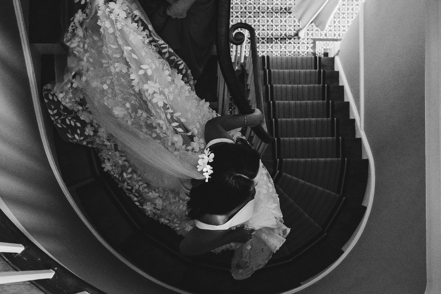 Black and white details of an intricate lace wedding dress train on display.