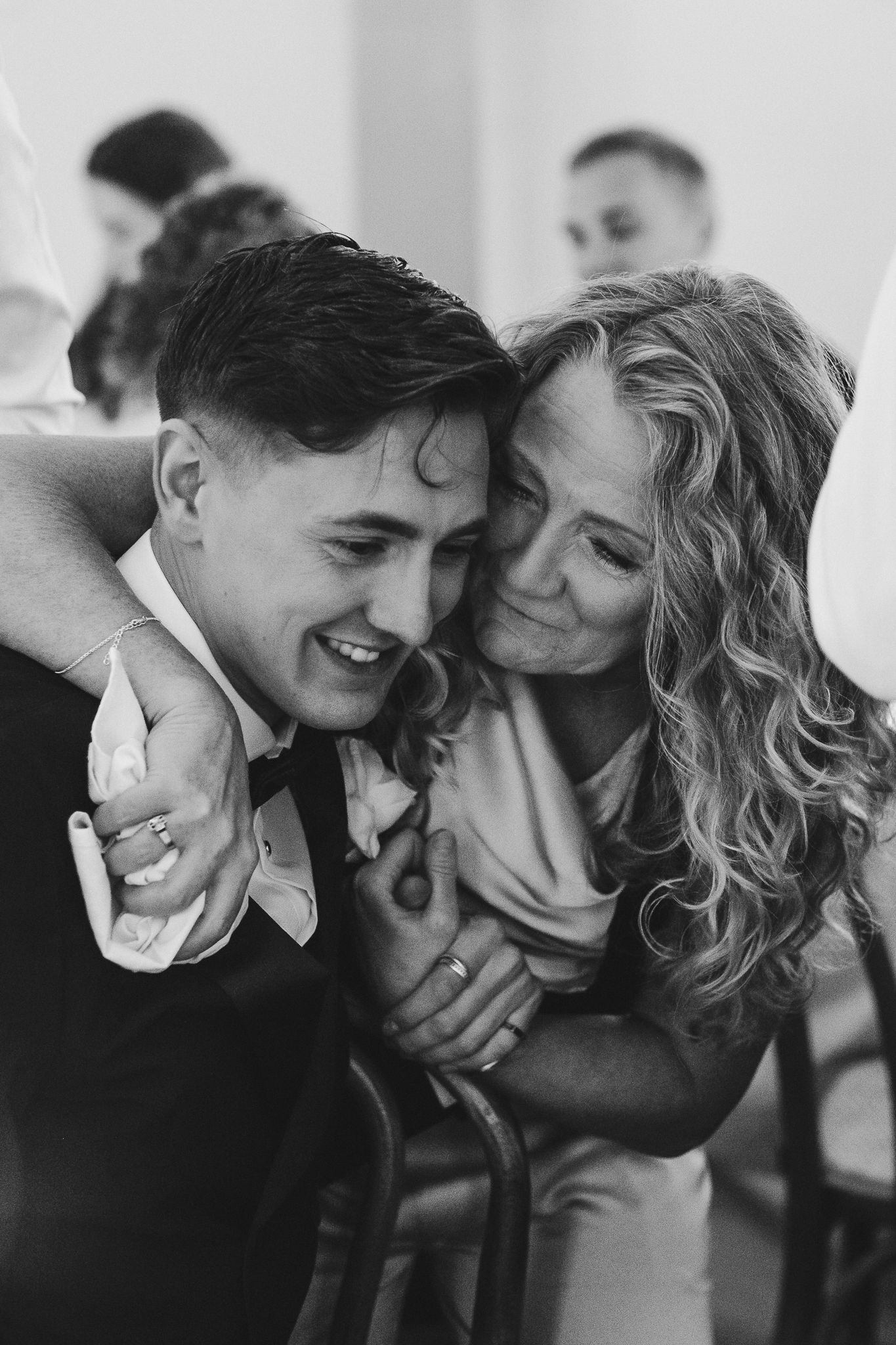 Black and white romantic photos showing intimate moments between a couple laughing and embracing together.
