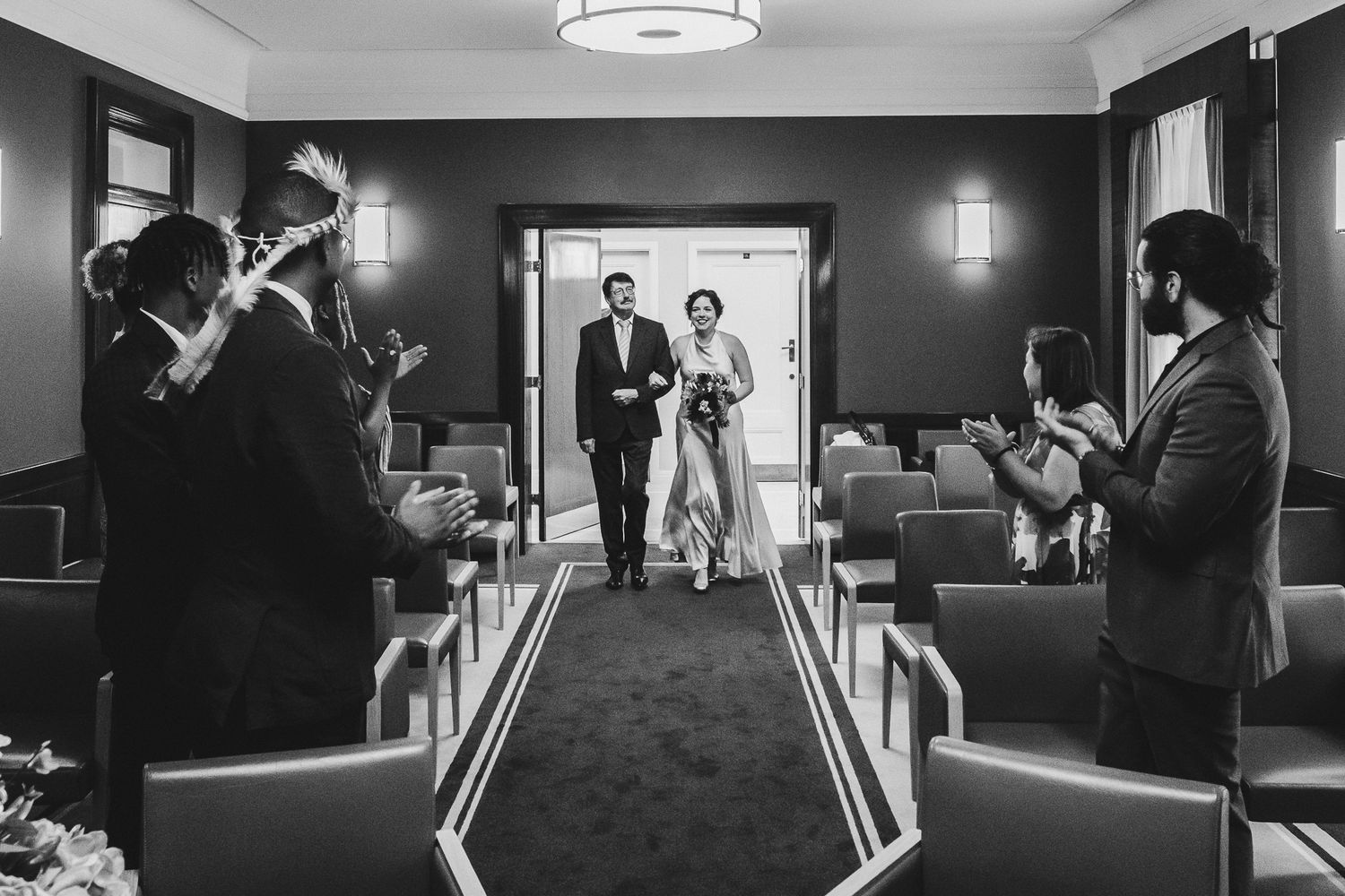 Black and white wedding photography collage showing couples in formal attire at an elegant indoor venue.