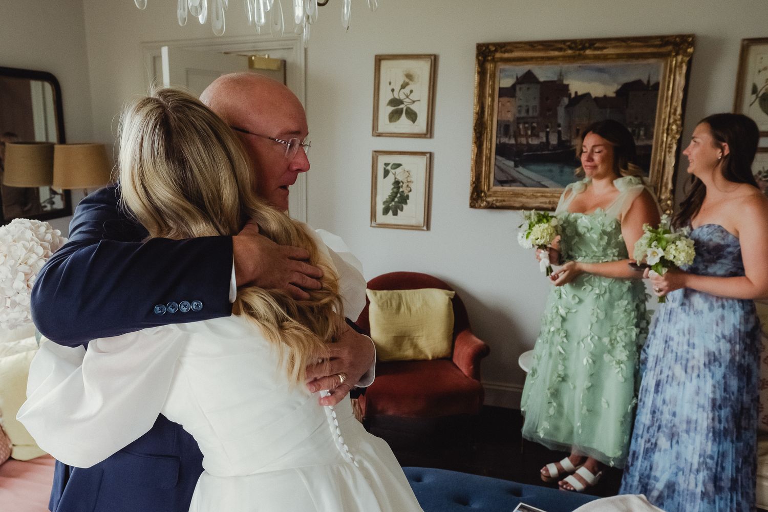 A series of candid wedding moments showing embraces and celebrations in an indoor venue with framed artwork on walls.