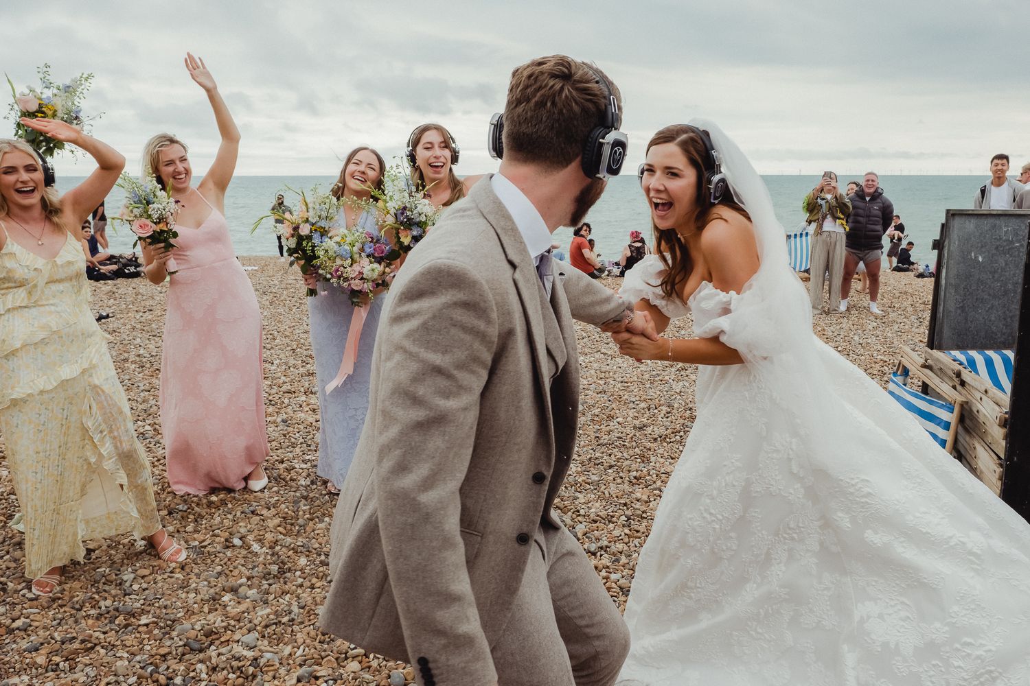 Wedding celebration on a beach with dancing and joyful moments in lovely soft lighting and natural decor.