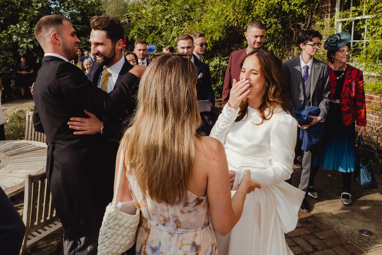 A series of candid moments captured at an outdoor wedding celebration with guests mingling and embracing.