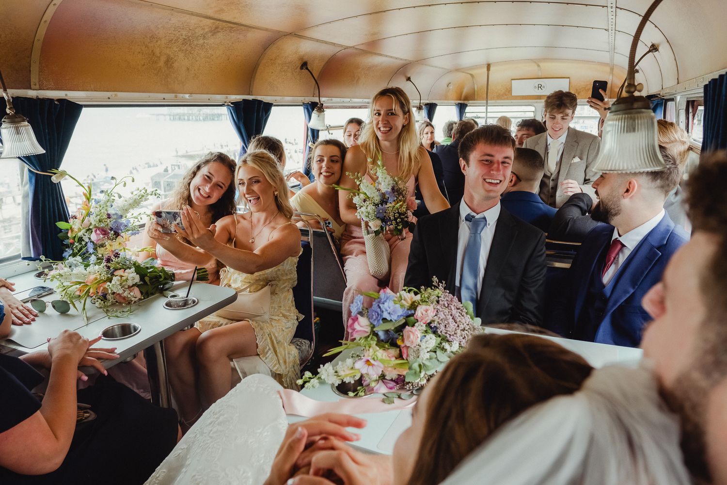 Guests celebrating and raising glasses in a toast during a wedding reception in an elegant venue.