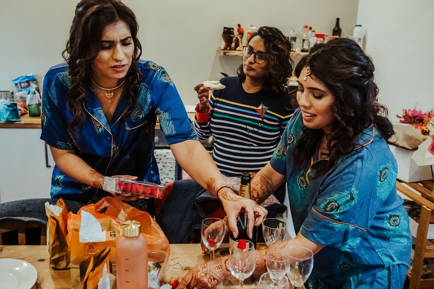 People enjoying drinks and conversations at indoor gathering.
