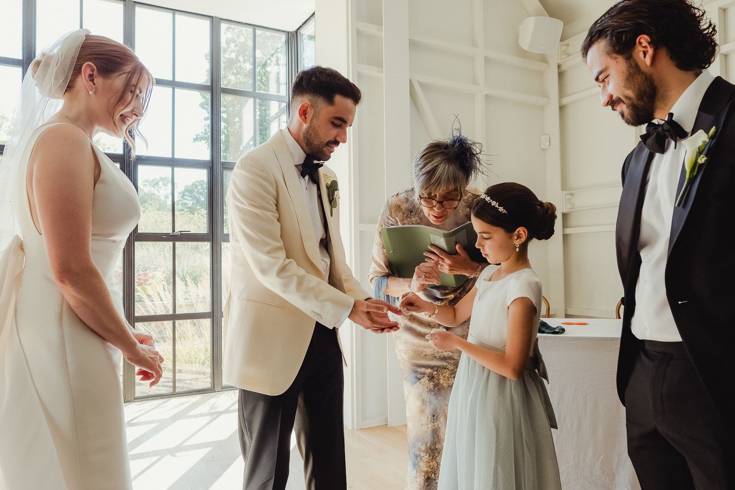 A series of wedding moments captured in a bright, sunlit venue showing couples and guests during the celebration.